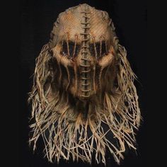 an animal's head is made out of straw and has long hair on it