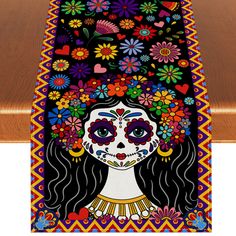 a table runner with a woman's face painted on it and flowers in her hair