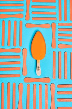 an orange and blue table with utensils laid out in rows on top of it