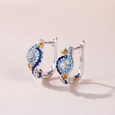 In a stunning display of style and craftsmanship, these earrings are brought to you. A combination of light blue, midnight blue, yellow gold and white stones, the earrings are a premium miniature version of Van Gogh's timeless Starry Night painting. This piece of work reminds us to trust our dreams and not believe the critics of the world. "There is always hope, even in the darkest of times." So trust your dream and let this alluring jewelry make a statement.Carat Weight: 2.584 ctStone Size: 2.5 Blue Diamond Earrings With Sparkling Stones, Blue Diamond Drop Earrings, Blue Diamond Drop Earrings With Accents, Blue Cubic Zirconia Earrings With Sparkling Stones, Light Blue Gemstone Earrings - Fine Jewelry, Luxury Blue Diamond Drop Earrings, Blue Topaz Multi-stone Earrings, Blue Diamond Earrings With Accents, Blue Diamond Earrings With Diamond Accents