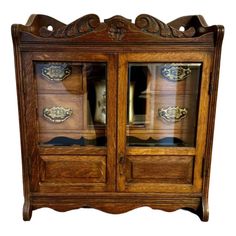 an old wooden cabinet with glass doors