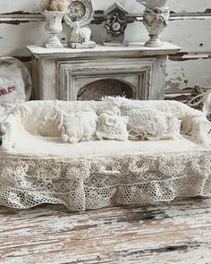 an old fashioned couch with lace on it