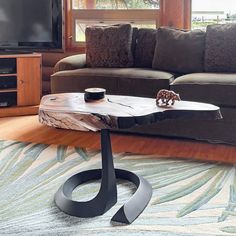 a living room with a couch, coffee table and television