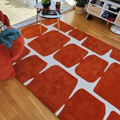 an orange and white rug in a living room