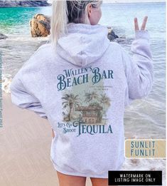 Get ready for the beach vibes with our Wallen Hoodie Sweatshirt, featuring our original Wallen's Beach Bar design inspired by Sand In My Boots. This hoodie is a country music shirt perfect for a concert or a day at the beach. Whether you're a music lover or just love the aesthetic of beach song lyrics, this hoodie is a fantastic choice for both style and comfort. **Also available in Comfort Colors garment dyed tee, see separate listing in our shop SIZING - please read 😊 *This is a 50/50 cotton Cotton Hoodie For Summer Vacation, Summer Vacation Cotton Hoodie, Summer Letter Print Hoodie Sweatshirt, Casual Beach Hoodie Top, Summer Casual Hoodie With Letter Print, Casual Summer Hoodie With Letter Print, Trendy Summer Beach Sweatshirt, Summer Hoodie Sweatshirt With Letter Print, Casual Hoodie Tops For Beach Season