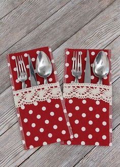 two red napkins with white polka dots and silverware on them are sitting next to each other