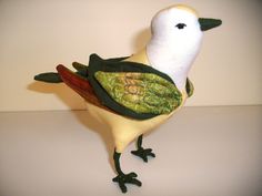 a white and green bird is standing on its hind legs