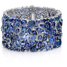 The Enchanted Evening Celeste Bracelet by Ruchi New York is a piece of fine jewelry that is sure to catch the eye of any woman looking for a unique and luxurious accessory. This stunning cuff bracelet is handcrafted with organic shapes of sapphire nuggets mixed with varying shades of faceted sapphires. The result is a one-of-a-kind piece that exudes sophistication and glamour. With 123.38 carats of blue sapphires and 1.64 carats of diamonds, this bracelet is truly a statement piece that will be Elegant Multi-stone Cuff Bangle Bracelet, Luxury Sapphire Gemstone Bracelets, Luxury Sapphire Bracelet Jewelry, Elegant Sapphire Multi-stone Bracelet, Fine Sapphire Bangle Jewelry, Elegant Multi-stone Sapphire Bracelet, Sapphire Gemstone Bangle Jewelry, Unique Formal Gemstone Bangle, Unique Formal Bangle With Gemstone