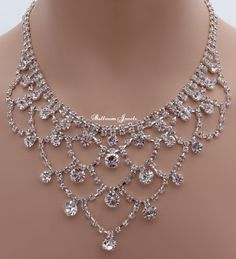 This is approximately a 16 inch necklace with a lobster claw hook in the back. It is 2.5 inches at the widest point. There is also a 4 inch extension. The pierced earrings drop approximately 2 inches at the longest point. Royalty Necklace, Royal Necklace, Luxury Crystal Bridal Necklace With Sparkle, Exquisite Crystal Wedding Necklace, Luxury Crystal Rhinestone Necklace For Wedding, Glamorous Luxury Crystal Bridal Necklace, Diamond Rhinestone Necklace For Wedding, Sparkling, Handmade Wedding Jewellery, 16 Inch Necklace