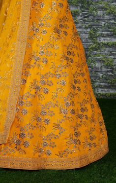 A perfect definition of superb craftsmanship in this beautiful Yellow colored designer sabyasachi bridal lehenga choli.
Beautified with amazing heavy embroidery with zari,dori & sequence work within the attire adds a sign of elegance statement with your look.
The semi-stitched lehenga is made of Thai Silk fabric accompanied with unstitched embroidered matching fabric blouse piece and embroidered Thai Silk dupatta.
Suitable to wear for wedding functions, engagement ceremony and special occasi Yellow Sharara With Dori Work, Yellow Chanderi Anarkali Set With Dori Work, Designer Yellow Salwar Kameez With Dori Work, Yellow Floor-length Dupatta For Reception, Gold Embroidered Raw Silk Choli, Yellow Anarkali Set With Dori Work For Eid, Yellow Silk Sharara With Dupatta, Gold Lehenga In Raw Silk With Resham Embroidery, Gold Embroidered Dola Silk Dress