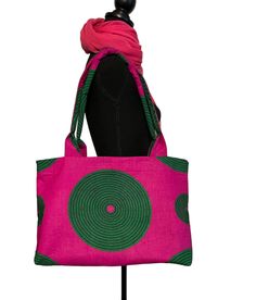 "This is a Vibrant Magenta and Emerald patterned Ankara Print Tote Bag. The striking pattern of this bag is truly captivating and perfect for those who love this color combination. This is a Medium size Tote Bag with a 16\" zipper closure. It features: -Ankara Fabric -Interior Zipper pocket -Interior Double Slip Pockets  -26\" Shoulder Strap -16\" zipper closure  Measures   18\" wide x 11\" height x 15.5 x 15.5\" base" Eco-friendly Green Shoulder Bag For On-the-go, Eco-friendly Pouch Shoulder Bag For On-the-go, Pink Rectangular Hobo Bag For Daily Use, Pink Rectangular Hobo Bag For Shopping, Green Rectangular Bag With Removable Pouch, Green Tote Shoulder Bag For On-the-go, Eco-friendly Green Top Handle Shoulder Bag, Green Tote Bag With Adjustable Strap, Eco-friendly Pouch Shoulder Bag For Shopping