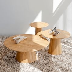 two wooden tables sitting on top of a carpeted floor