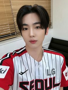 a young man in a baseball uniform posing for a photo