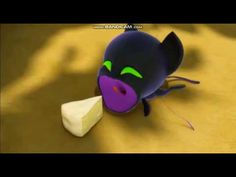 a purple cat with green eyes eating a piece of cheese