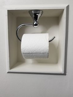 a white toilet paper holder with a roll of toilet paper in it