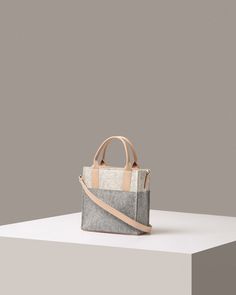 Jaunt Merino Wool Felt Mini Crossbody in Grey and Beige | Graf Lantz Wine Carrier Bag, Wine Markers, Wool Tote, Wine Carrier, Bottle Bag, Carrier Bag, Accessory Pouch, Mini Tote, Grey And Beige