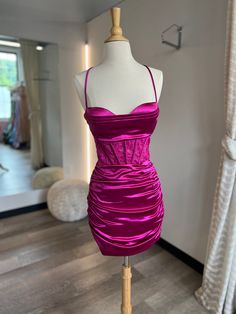 a mannequin with a purple dress on display