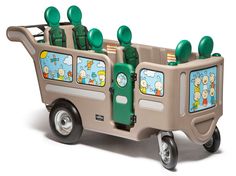 a toy bus with green seats and cartoon characters on the front, sitting upright against a white background