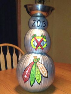 a metal snowman sitting on top of a wooden table