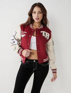 Game on with the True Varsity Jacket. This women's varsity jacket features a wool blend body, snap front, and striped ribbed trim at the collar, cuffs, and hem. Finished with side pockets and varsity inspired chenille logo patches at the chest, sleeves, and across the back. Style: 207120 Red Collegiate Varsity Jacket For Fall, Long Sleeve Varsity Jacket For Game Day In Fall, Long Sleeve Varsity Jacket For Fall Game Day, Fall Varsity Jacket For Campus, Trendy Fall Varsity Jacket For College, Trendy Varsity Jacket For College In Fall, Trendy College Varsity Jacket For Fall, Sporty Fall Outerwear For Game Day, Sporty Outerwear For Game Day In Fall