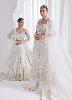 Bridal Lehenga Kameez White Pakistani Wedding Dress is an elegant attire that will give you a head-turning look on the most important day of your life. Lavish designs and perfect stitching make this Pakistani Bridal Dress a perfect choice to wear on the Nikkah day. Lehenga Kameez: The kameez in premium net fabric is intricately emblazoned with zardosi, motifs, and embroidery. This kameez in an alluring white shade is adorned with heavily embellished silverwork, naqshi, stones, sequins, and beami Elegant Semi-stitched Wedding Dress With Traditional Drape, Semi-stitched Wedding Dresses, Floor-length Sharara With Intricate Embroidery For Weddings, Luxury Wedding Gown With Dupatta In Traditional Drape, Traditional Drape Wedding Gown With Dupatta, Floor-length Resham Embroidered Wedding Dress, Eid Wedding Gown With Traditional Drape, Bollywood Style Wedding Gown With Resham Embroidery, Elegant Semi-stitched Wedding Dress With Zari Work