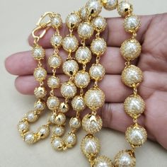 Handmade with Semi precious pearl from India. Beautiful round shape accented with gold filled net on pearl beads. Finished with a gold plated chain and clasp. Length of necklace: 24 inches A BLEND OF TREND AND TRADITION' Comes in a gift box and free shipping in the US. Festive Gold Plated Pearl Chain Necklace, Pearl Chain Necklace With Round Beads, Gold Plated Pearl Necklace For Celebrations, Gold Plated Pearl Chain Necklace For Celebrations, Gold Pearl Drop Necklace With Round Beads, Gold Beaded Chain Bridal Necklace For Party, Formal Gold Pearl Necklace With Polished Beads, Gold Bridal Necklace With Beaded Chain For Party, Gold Bridal Necklace With Beads For Party