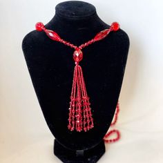 Beautiful, shimmering ruby red glass (likely crystal) beaded sautoir necklace. Art Deco era. A sautoir is a French term for a long necklace that suspends a tassel or other ornament. This amazing vintage collectible will add drama to a dress, tunic or even a t-shirt & jeans. In excellent vintage condition. No chips or imperfections. Necklace approximately 38" long, tassel is 4" long. Elegant Red Long Necklace With Round Beads, Red Beaded Long Necklace For Gift, Red Beaded Long Necklace As Gift, Elegant Handmade Red Long Necklace, Formal Red Beaded Necklace, Evening Costume Jewelry Necklace With Faceted Beads, Vintage Red Beaded Necklaces For Party, Vintage Red Necklace For Celebration, Red Vintage Necklace For Celebration