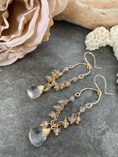 One of a kind gemstone dangle earrings .. crafted with hand forged gold tone accents with delicate gold tone chain and Rose Quartz gemstones accented with hand wire wrapped clear Quartz gemstones . These sweet beauties measure 3.5 inches in length . Wire Wrapped Drop Chandelier Earrings As Gift, Wire Wrapped Chandelier Drop Earrings For Gift, Beaded 14k Gold Filled Dangle Earrings, 14k Gold Filled Beaded Dangle Earrings, Gold Wire-wrapped Crystal Earrings, Gold Wire Wrapped Crystal Earrings For Wedding, Wire Wrapped Briolette 14k Gold Filled Earrings, Gold Briolette Crystal Earrings With Ear Wire, Gold Wire Wrapped Crystal Earrings