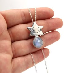 This sterling silver star girl charm necklace features beautiful blue 12mm moonstone. So dreamy!The pendant is about 1 3/8 inches tall and 3/4 inch wide.Each piece is cast in sterling silver from hand carved wax, using the lost wax technique. Then, I solder the bezel and set the stone.The necklace is shipped on a silver plated cable chain. You can choose your chain length the drop down menu.Go here to see all my charm and gemstone jewelry:https://www.etsy.com/shop/marmar?ref=seller-platform-mcna Girl Necklace, Funky Jewelry, Moonstone Necklace, Moonstone Jewelry, Cat Necklace, Necklace For Men, Girls Necklaces, Lost Wax, Star Girl