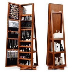 a large wooden jewelry cabinet sitting next to a mirror on top of a white floor