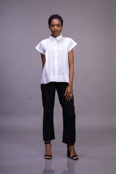 White organic cotton button down drop shoulder woman's top with magyar sleeve, shirt collar and textured back yoke. this is an excellent gift for a loved one in the family like your mother , daughter or someone close. Geometric folds are created on fabric using the technique of Shadowfolding, which is made from a single three step process. The flexible property of the organic cotton allows pleats to be folded to augment and give a dimensionality not present in a flat surface; and the translucent Effortless Relaxed Fit Collared Tops, Effortless Collared Relaxed Fit Tops, Effortless Cotton Shirttail Hem Top, Effortless Cotton Top With Shirttail Hem, Cotton Blouse With Relaxed Fit For Everyday, Relaxed Fit Cotton Blouse For Everyday, Everyday Relaxed Fit Cotton Blouse, Relaxed Fit Cotton Blouse For Daywear, Effortless Short Sleeve Workwear Tops