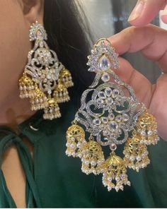 A beautiful pair which highlights the regal traditions and beyond! Beautifully handcrafted dangler style earrings encrusted with navratan and zircon stones. Approximate earrings length is 3.2″