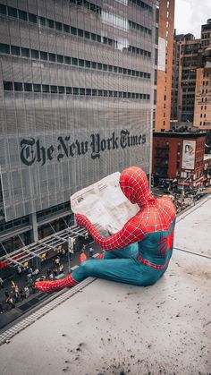 a person sitting on the ground reading a newspaper