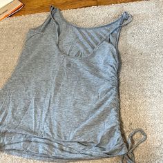 Grey Scrunched Lulu Lemon Tank Top Very Cute Never Worn Casual Fitted Top With Ruched Back, Fitted Casual Top With Ruched Back, Stretch Workout Top With Ruched Back, Casual Sleeveless Top With Ruched Sides, Casual Ruched Back Top For Spring, Casual Ruched Sides Tank Top For Summer, Casual Ruched Stretch Tank Top, Casual Stretch Ruched Tank Top, Spring Workout Ruched Tops