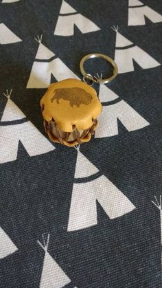 a keychain with a small piece of food on it sitting on top of a table