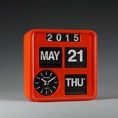 an orange alarm clock with the date may 21st