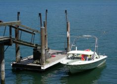 a small boat is docked at the dock