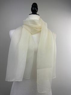 "Measures 20\"Wx65'\"L rectangular scarf.  Poly chiffon sheer transparent scarf. Suitable for size Small and Medium as a shawl. Beautiful translucent scarf for Fall and Spring fashion. This fashionable versatile sheer chiffon shawl can be used to dress up an outfit for a special evening, a wedding or as a neck scarf. Effortlessly give a dress a new look by simply adding this shawl. Perfect as bridesmaid gifts or wedding favours, the perfect gift for any occasion. Mix and match with similar or co Elegant Solid Color Silk Scarf For Summer, Elegant Solid Silk Scarf For Summer, Classic White Silk Scarf For Formal Occasions, Elegant Organza Silk Scarf For Summer, Classic White Silk Scarf For Gift, Elegant Cream Silk Scarf As A Gift, Elegant Cream Silk Scarf As Gift, Elegant Cream Silk Scarf For Gift, Classic White Scarf For Formal Occasions