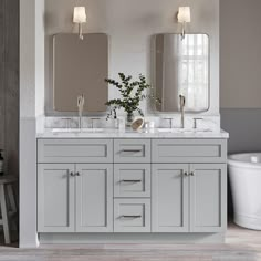 a bathroom with two sinks and mirrors on the wall