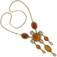 For Sale on 1stDibs - During the 19th century, the discoveries of ancient archaeological finds influenced what is referred to as 'archaeological revival jewelry,' or 'Egyptian Antique Amber Pendant Necklace, Antique Amber Pendant Necklaces, Antique Amber Gemstone Necklace, Antique Amber Necklace With Gemstone, Victorian Cabochon Pendant Necklace, Victorian Pendant Necklace With Cabochon, Traditional Formal Cabochon Necklace, Traditional Cabochon Necklace For Formal Occasions, Antique Yellow Gold Necklace With Cabochon