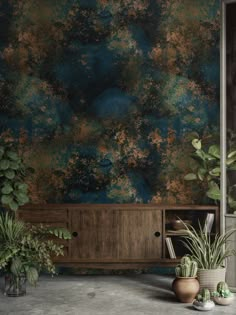 two potted plants sit in front of a wall with an artistic painting on it