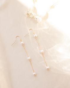 Inspired by bridal season, these freshwater pearl dangle earrings are the perfect statement piece. 3 sweet fresh water pearls embellished down our favorite sparkly chain for the most delicate accent. Details: -Gold Filled, Sterling Silver -3 freshwater pearls, 6mm in size -Drop of earring is 2.5 inches -Waterproof, Tarnish Resistant, Hypoallergenic Delicate Pearl Drop Linear Earrings For Party, Feminine Pearl Earrings With Pearl Chain, Dainty Pearl Drop Linear Earrings, Delicate White Linear Earrings With Pearl Charm, Pearl Chain Dangle Earrings, Pearl Dangle Earrings With Pearl Chain, Pearl Charm Dangle Bridal Earrings, Pearl Dangle Linear Earrings For Pierced Ears, White Dangle Linear Earrings With Pearl Chain