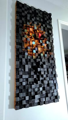 a piece of wood that has been made to look like an abstract painting on the wall