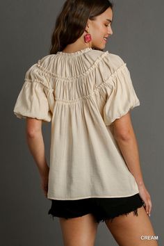 Experience effortless style and comfort with our Kate Modal Pleated Split Neck Ruffle Top in Cream! Made from soft modal fabric, this top features delicate pleating, a flattering split neck, and charming ruffle details. Elevate any outfit with this versatile and elegant top. Feminine Cream Ruffle Sleeve Tops, Cream V-neck Tops With Ruffles, Chic V-neck Smocked Top With Ruffles, Feminine V-neck Smocked Top With Ruffles, Bohemian V-neck Top With Ruffle Hem, Cut Top, Neck Ruffle, Shoe Gifts, Ruffle Top