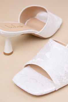 You'll be obsessed with the amount of compliments coming your way when you step out wearing the Lulus Maeler White Lace High Heel Slide Sandals! These ultra-romantic, lace-covered heels feature a trendy square footbed and an extra-wide vamp strap. A sculpted kitten heel completes the sleek slide-on design. 2. 5" sculpted heel. Lightly cushioned insole. Felted rubber sole has nonskid markings. Man made materials. Imported. Lulus | Maeler White Lace High Heel Slide Sandal Heels | Size 9. Feminine Block Heel Wedding Shoes For Summer, Feminine Wedding Sandals With Padded Heel, Feminine Summer Wedding Shoes With Block Heel, Feminine Open Toe Heels For Events, Lace High Heels For Party, Feminine Summer Wedding Guest Shoes, Feminine Wedding Shoes For Wedding Guests, Lace Heels With Ankle Strap For Party, Lace Ankle Strap Heels For Party