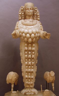 an ancient statue is displayed on a table