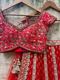 A three-piece red bridal sharmily embroidered lehenga set from the Priti Sahni collection. This beautiful and graceful georgette red butti bridal panel lehenga with a heavy border of gota, pearl, sequin, zari detail is paired with a red raw silk blouse with zardozi, sequin, & hand-embroidery work. The zari panelled lehenga has side hanging ball tassels to the waistline. And the blouse has a sequin-bead tassel tie-up at the back. This outfit is completed with a red tulle sequin butti dupatta with Ruffle Lehenga, Raw Silk Blouse, Raw Silk Lehenga, Georgette Lehenga, Add Sleeves, Green Lehenga, Blue Lehenga, Pink Lehenga, Lehenga Blouse