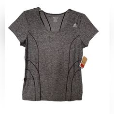 Designed With Active Woman In Mind, This Short-Sleeve Tee Is Is Made Of Moisture-Wicking Fabric For Dryness And Comfort. Its Slim Styling Is Designed To Move With An Active Body. Although It’s Reebok Color Is Called Black Heather, It Is More Of A Dark Gray Hue. Pit To Pit: 19” Neck To Hem: 24 1/2” Side To Side At Hem: 19” From A Smoke-Free Home. Gray Short Sleeve Tops For Light Exercise, Gray Casual Top For Light Exercise, Casual Gray Top For Light Exercise, Casual Gray Tops For Running, Sporty Gray Tops For Light Exercise, Fitted Casual T-shirt For Running, Green Bay Packers Shirts, Teal Shorts, Reebok Women