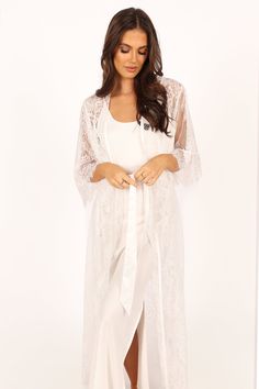 DETAILS
  This soft floral lace robe is the perfect addition to your lingerie wardrobe. With a long length style and relaxed sleeves, it's perfect for those romantic nights in or out on the town. The wrap front design of this luxurious robe ensures a flattering fit, while the detachable waist tie provides extra security and comfort.

soft floral lace robe
long length style robe
long lace sleeves
wrap front design
detachable waist tie
unlined

material - 100% polyester









SIZING

model is 5 Long Lace Robe For Wedding Night, Feminine Long Sleeve Lace Sleepwear, White Lace Patchwork Sleepwear For Loungewear, Feminine Lace Robe For Wedding Night, Elegant Long Sleeve Lace Sleepwear, Delicate Lace Robe For Wedding Night, Elegant Long Lace Trim Kimono, Elegant Long Kimono With Lace Trim, Feminine Kimono For Wedding Night