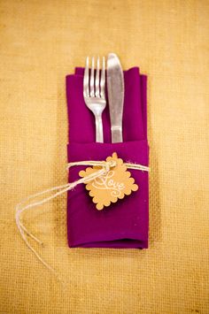 a fork, knife and napkin wrapped in twine